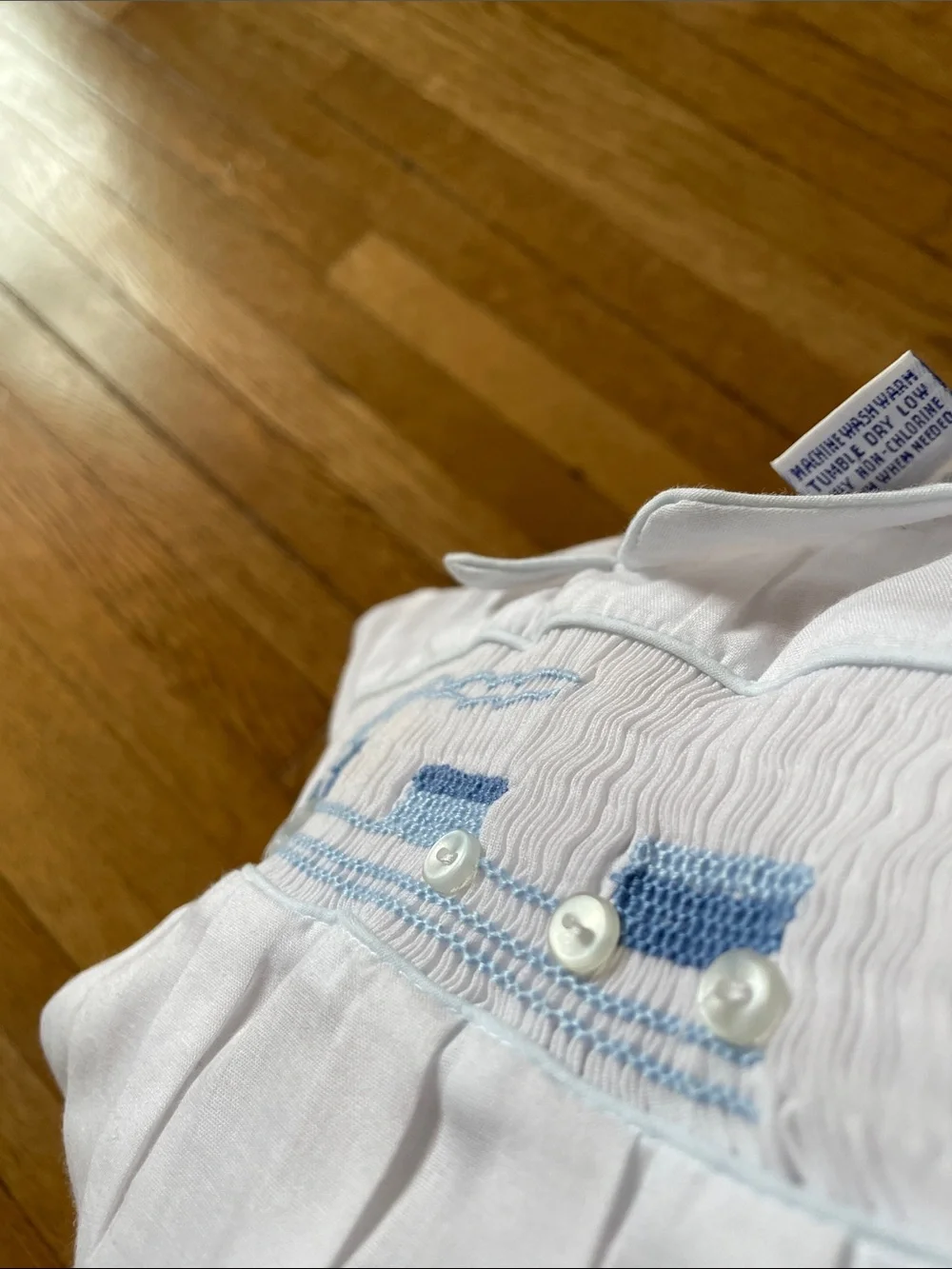 White Baby Bubble Romper with Blue Smocked Train Detail